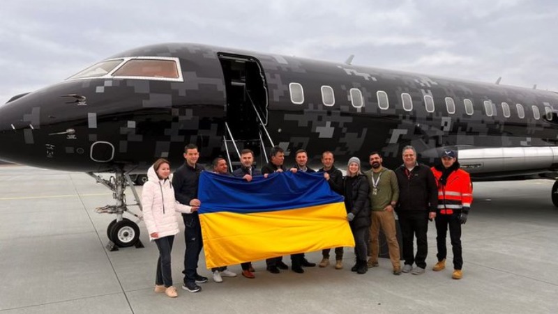 Representatives from the Polaris Program hold a Ukrainian flag that will fly into space later in 2022.